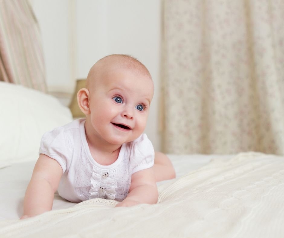 Six-month-old baby looking up at the camera