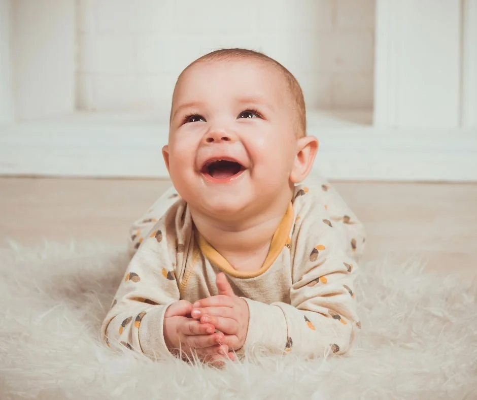 Smiling six month old baby with bright, alert eyes