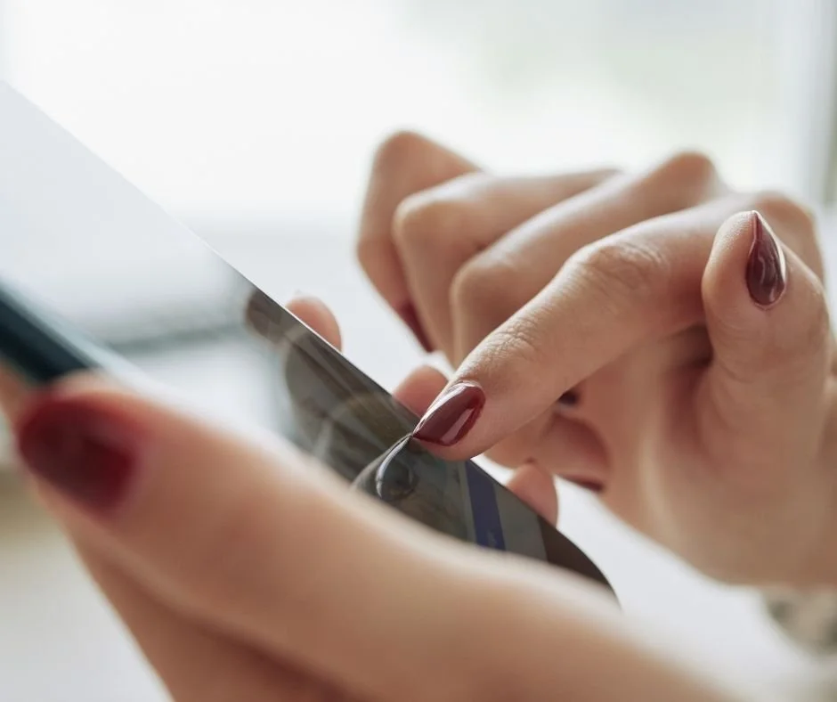 Close up of mobile phone being held and finger touching the screen