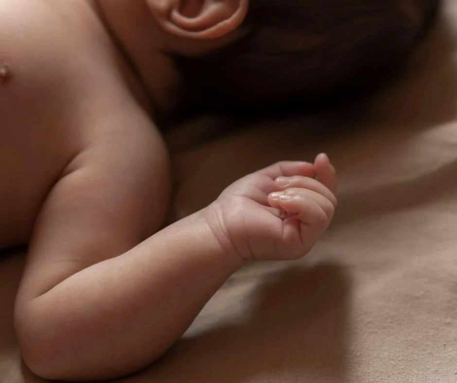 Baby sleeping with focus on hand