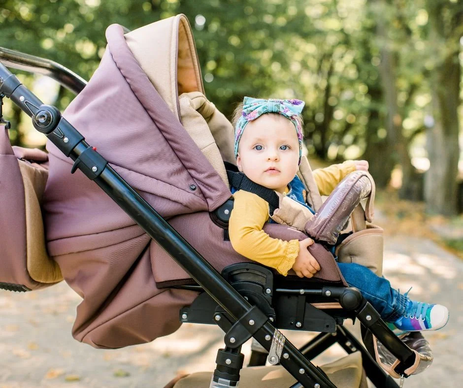 Baby in pushchair on morning walk outdoors to support circadian rhythm after the clock change