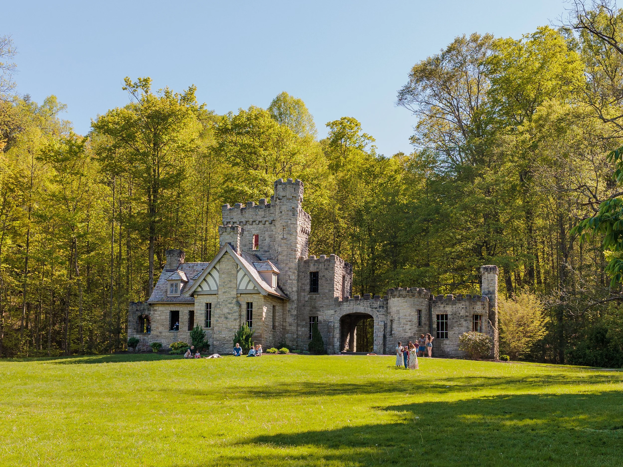 Beautiful stone castle with bright green trees surrounding it