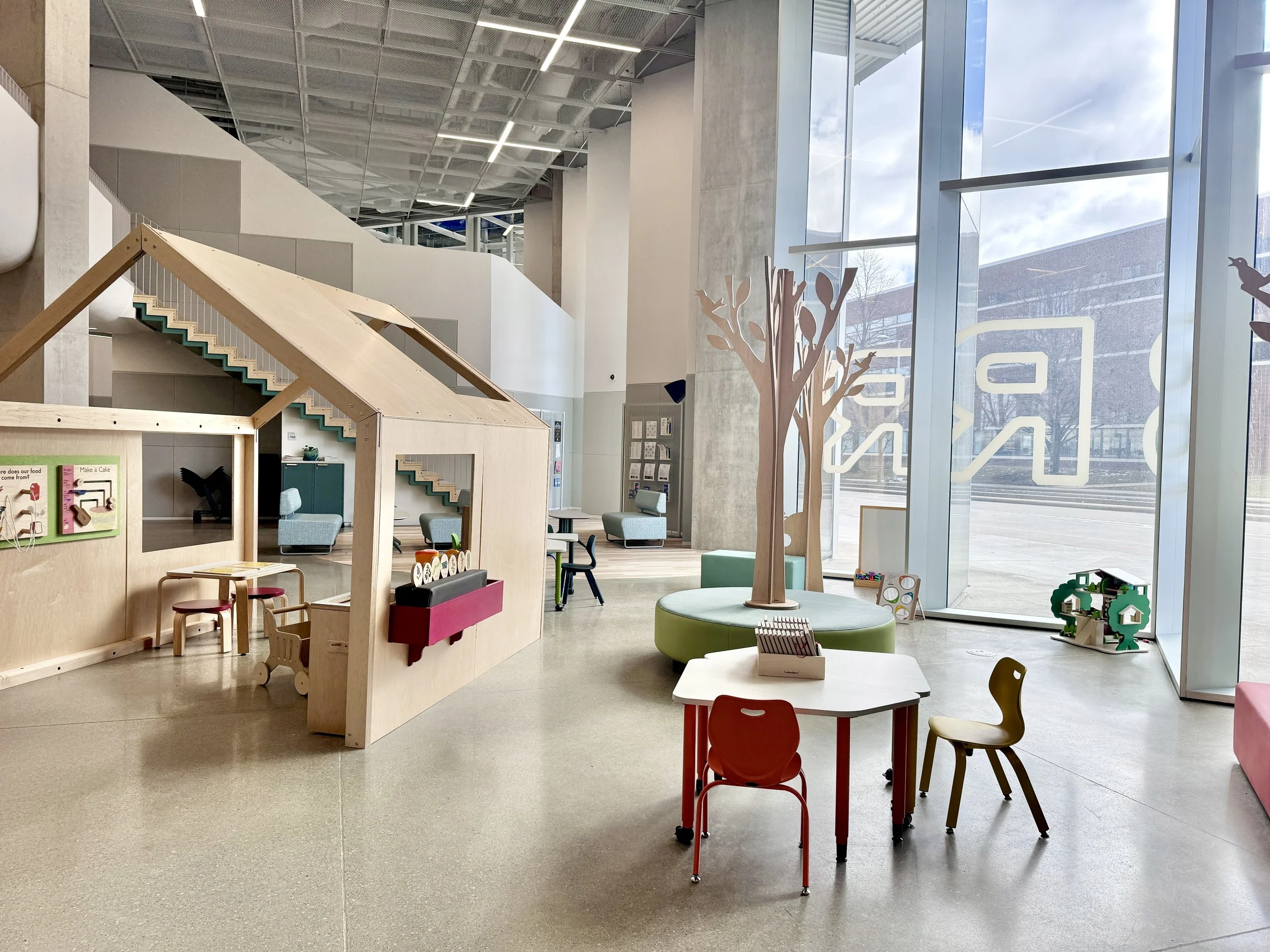 bright open space with a wooden play house for kids and wooden trees