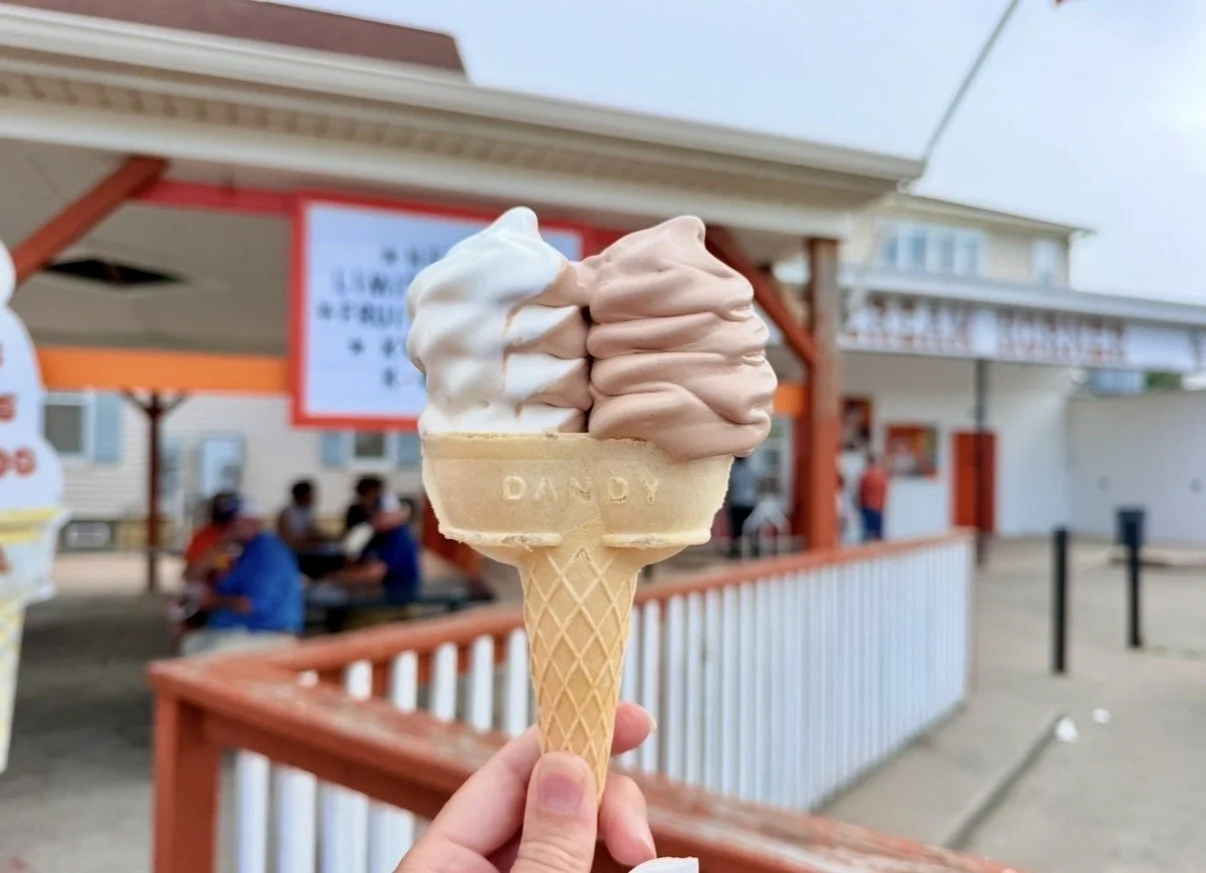 a double cone of ice cream with chocolate and vanilla swirl ice cream on both cones