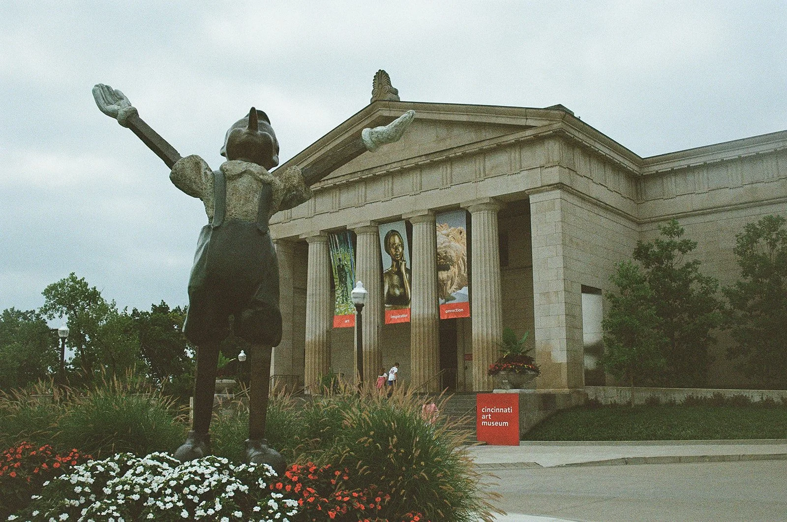 Statue with arms outstretched in front of Cincinnati Art Museum shot on film