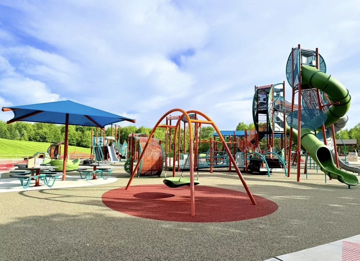 LArge playground with a huge curly slide and saucer swing