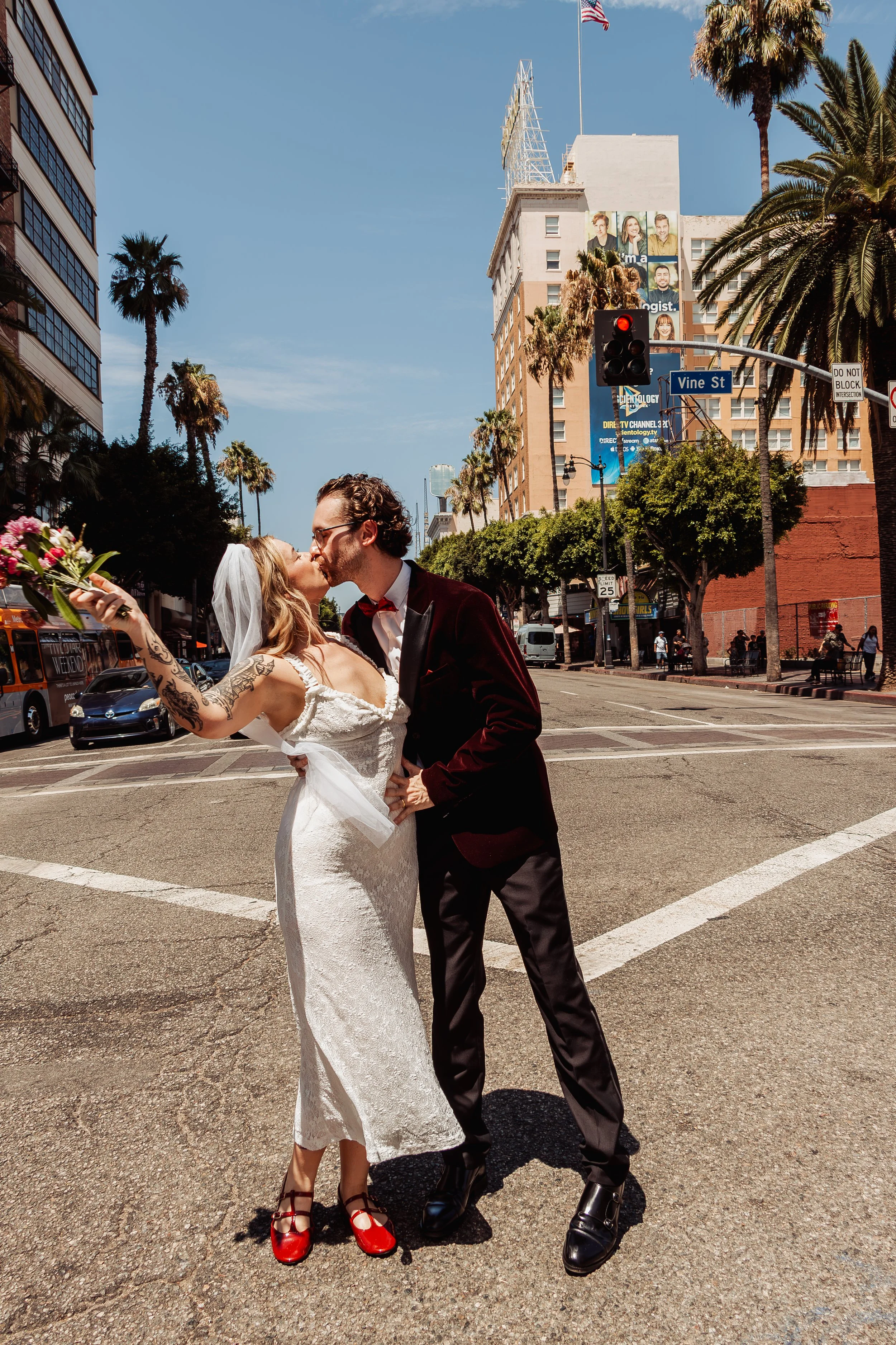 Couple kissing in the street on Hollywood Blvd during their Cakewalk elopement.