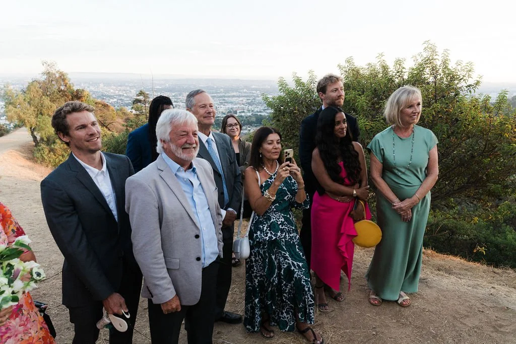 Family watching a couple's wedding ceremony at the lookout over the Los Angeles Basin from Griffith Observatory.