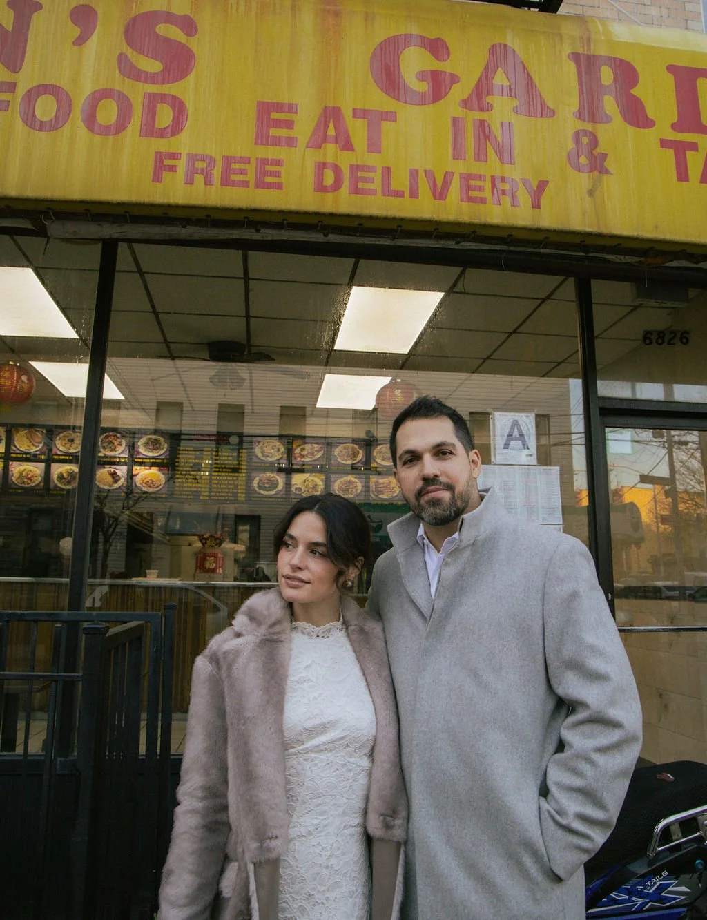 Couple outside a Chinatown restaurant after their small NYC wedding ceremony