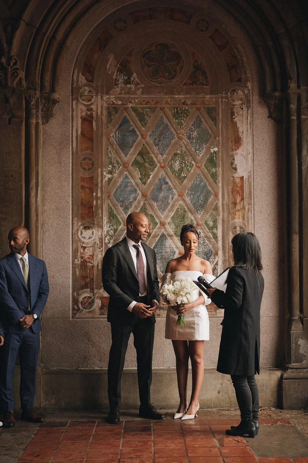 Bride and groom being married by Cakewalk officiant at Bethesda Terrace during their micro wedding ceremony.