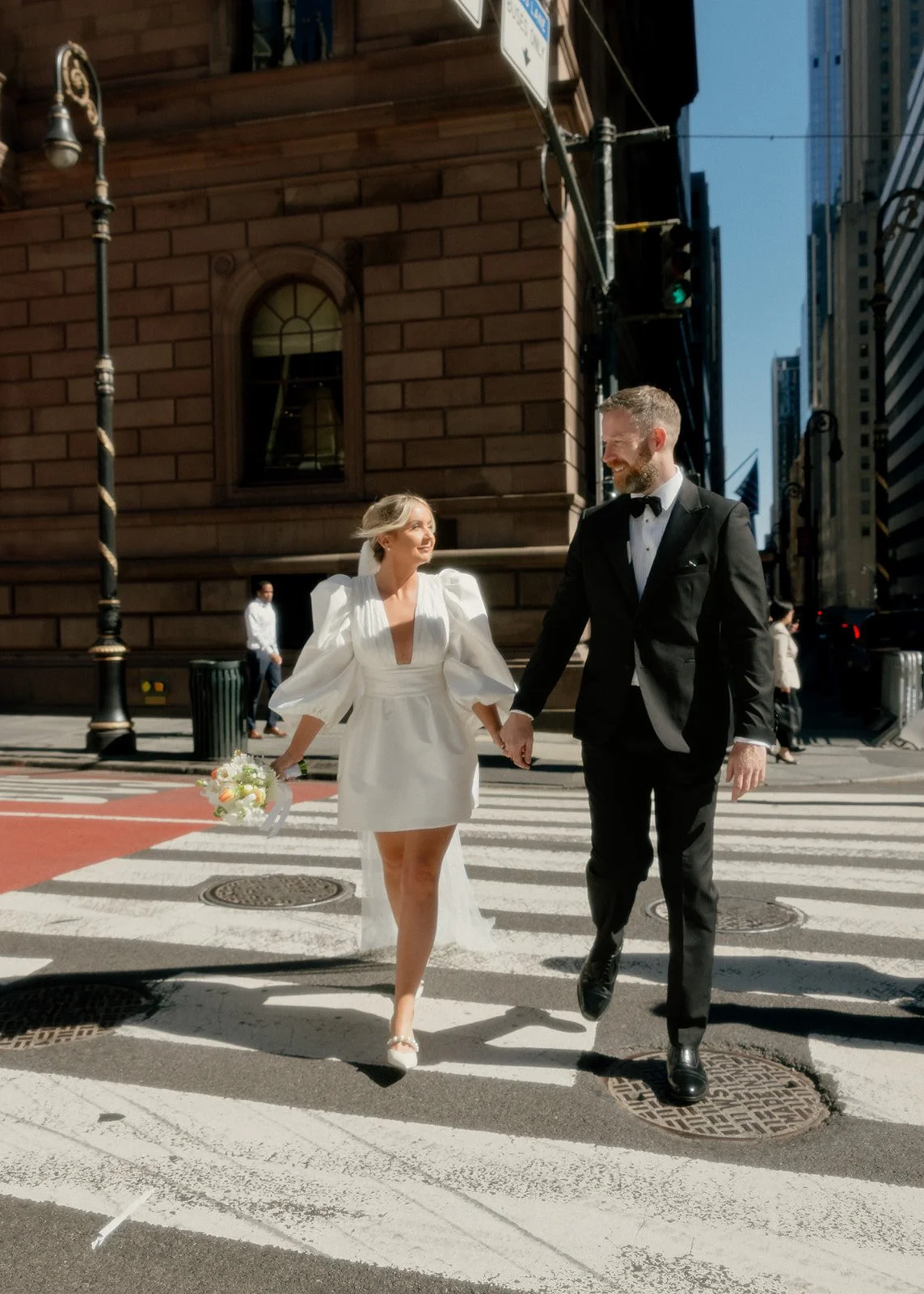 Bride and groom crossing the street in Brooklyn, on the way to their wedding ceremony by Cakewalk.