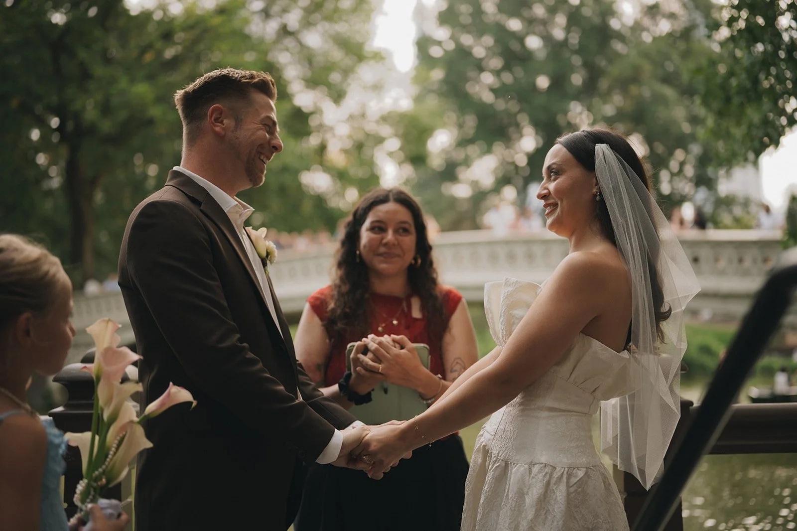 Outdoor elopement ceremony by a river with officiant and flower girl at a Cakewalk NYC wedding