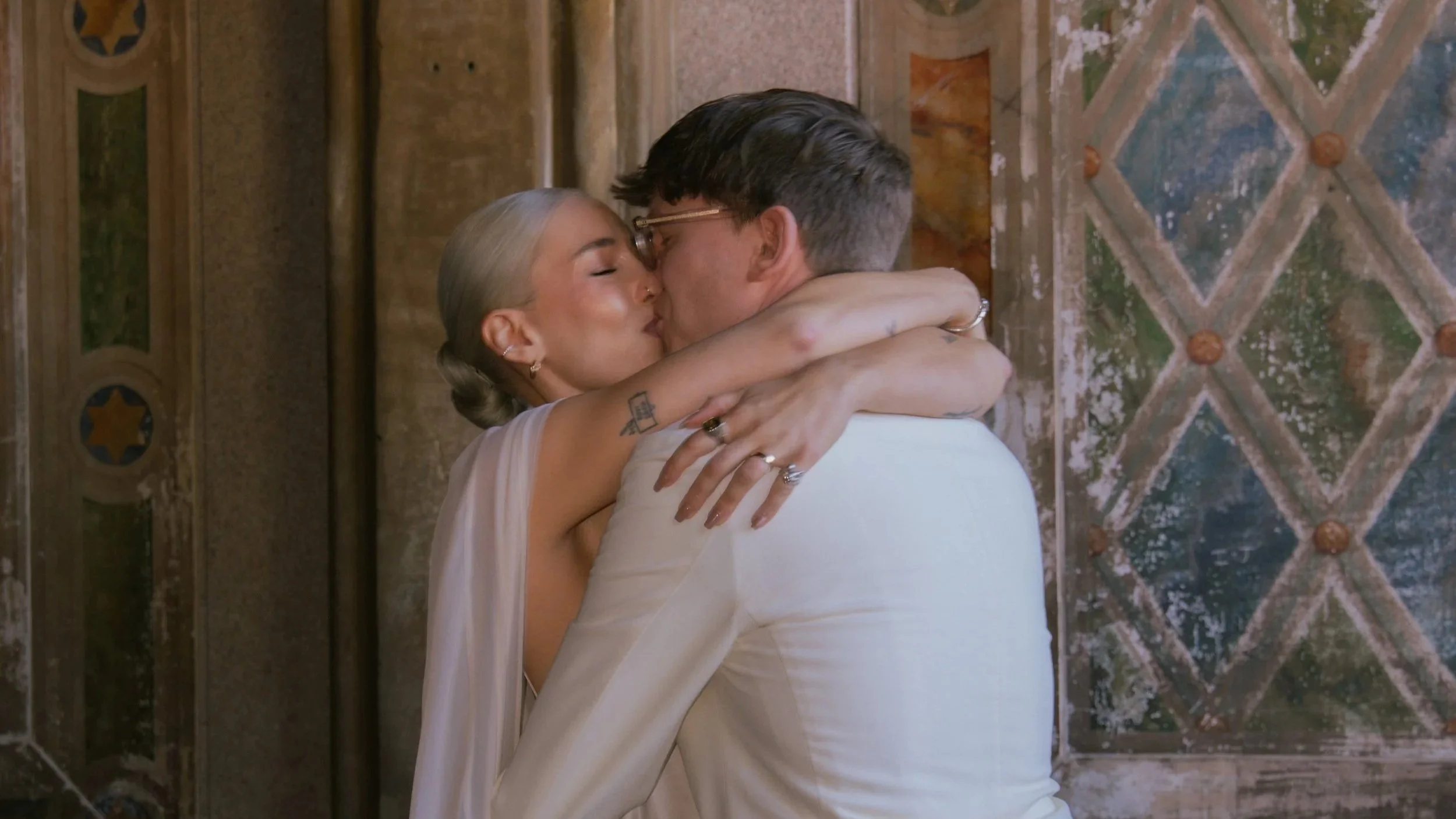 Coupe kissing in motion blur image at Bethesda Terrace after their elopement wedding
