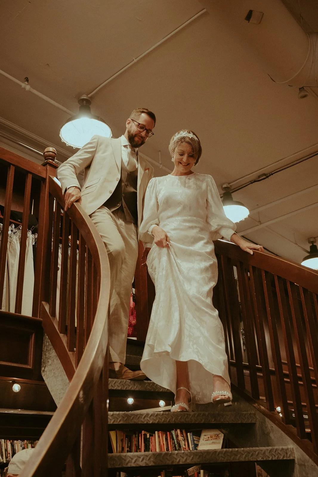 Couple captured in documentary style photography descending the stairs at Housing Works Bookstore on Crosby Street