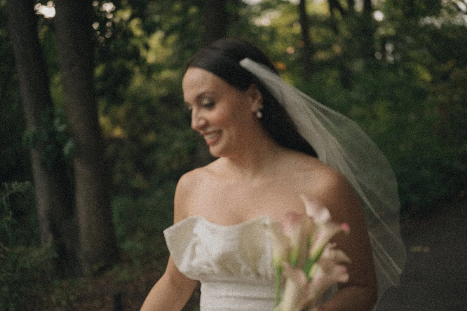 Bride walking through Central Park before her elopement ceremony