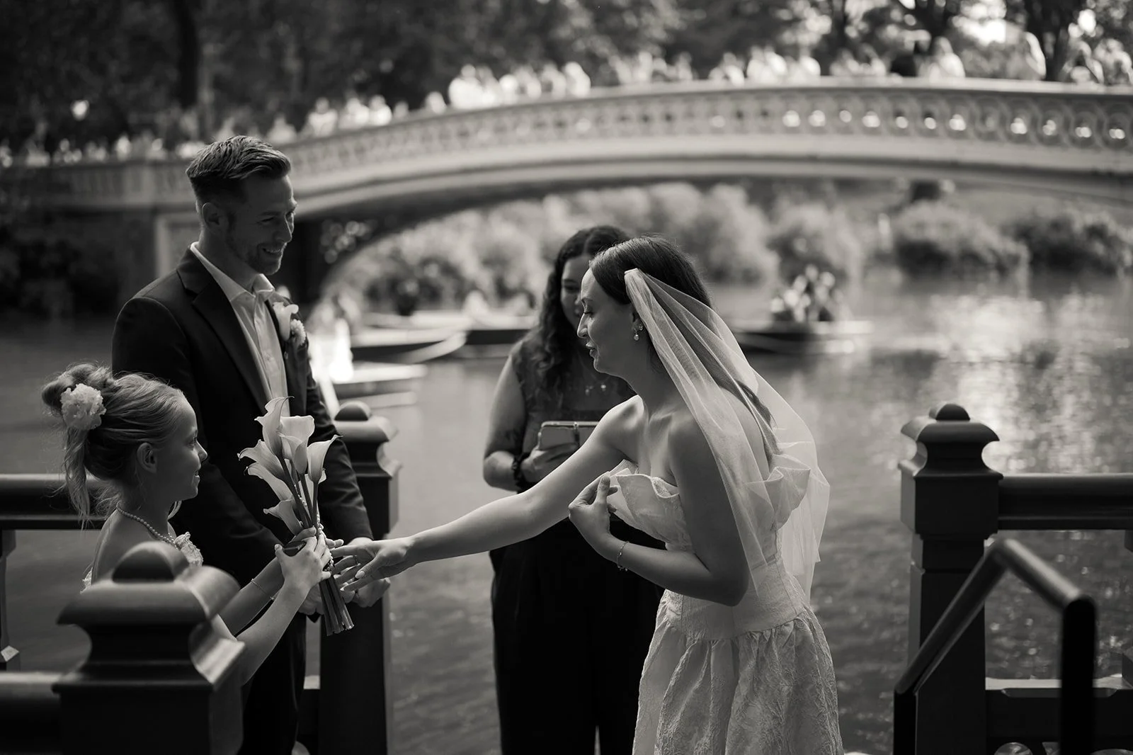 Couple exchanging vows during a Central Park elopement near Bow Bridge