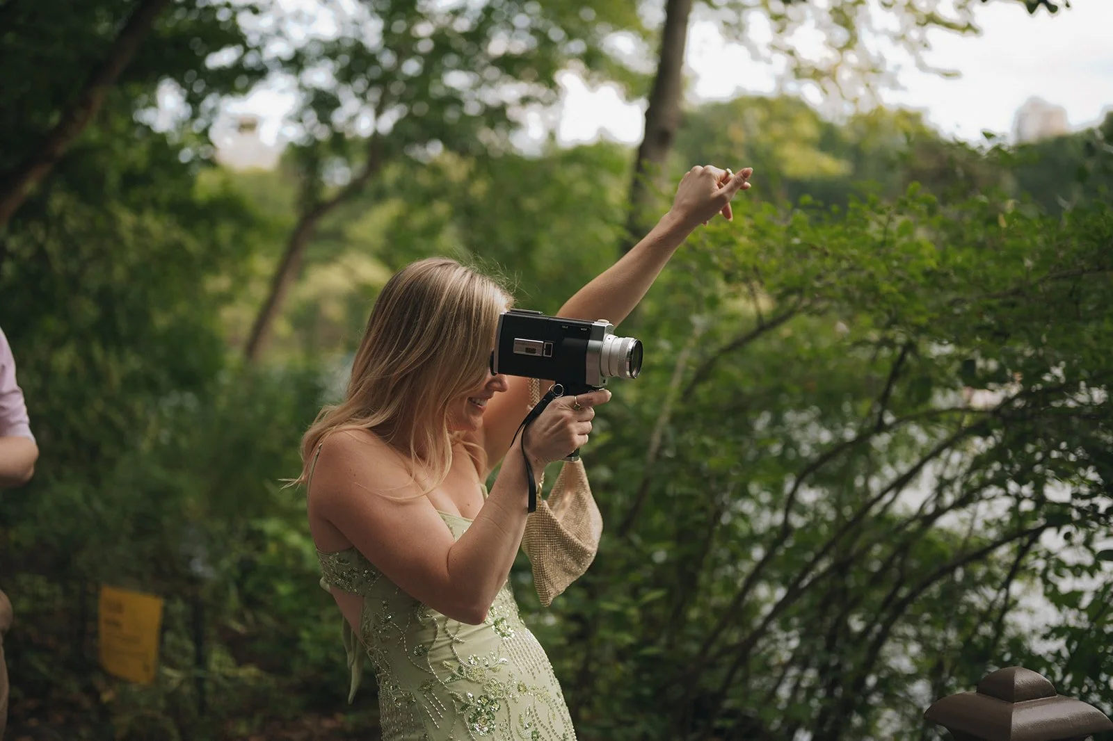Guest filming a Central Park elopement ceremony on a vintage Super 8 camera