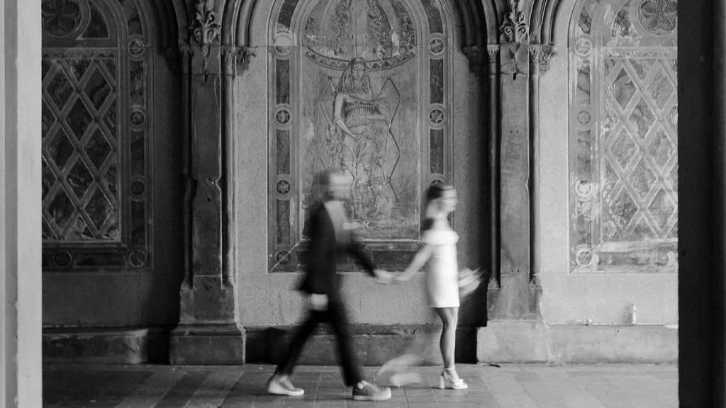 Chloe and Sam walking through the historic tiled archway at Bethesda Terrace in Central Park after their Wagner Cove elopement.