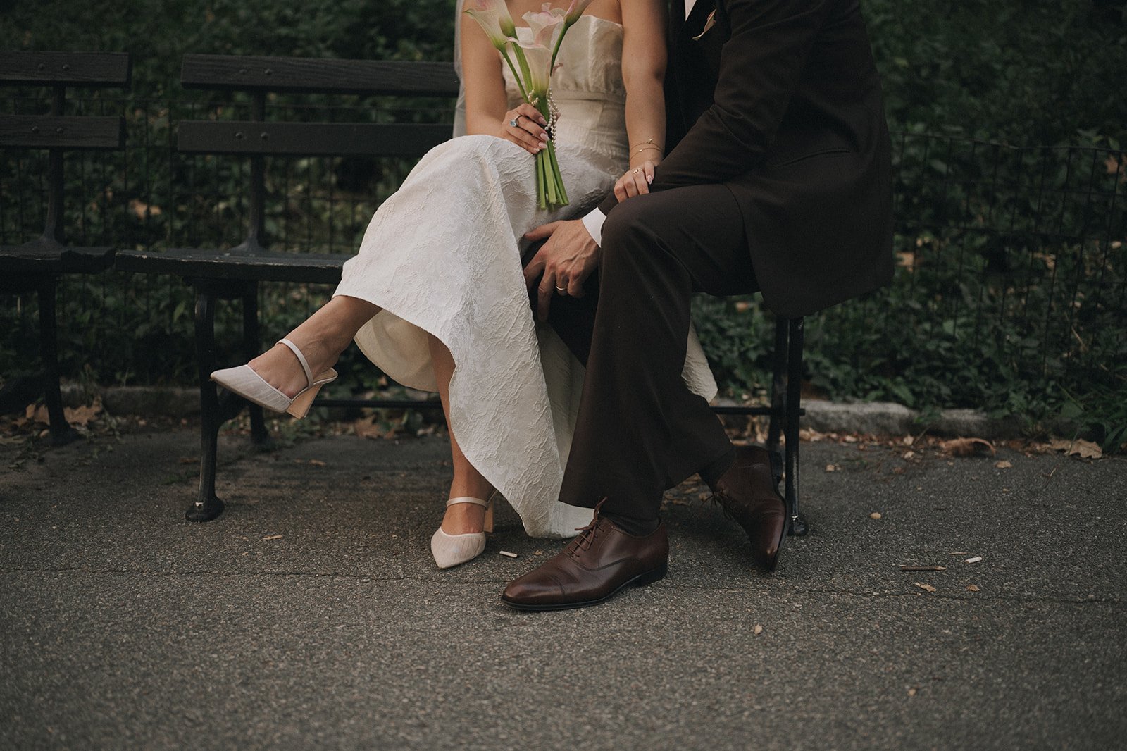 Bride and groom sitting on park bench in Central Park after their Cakewalk micro wedding.