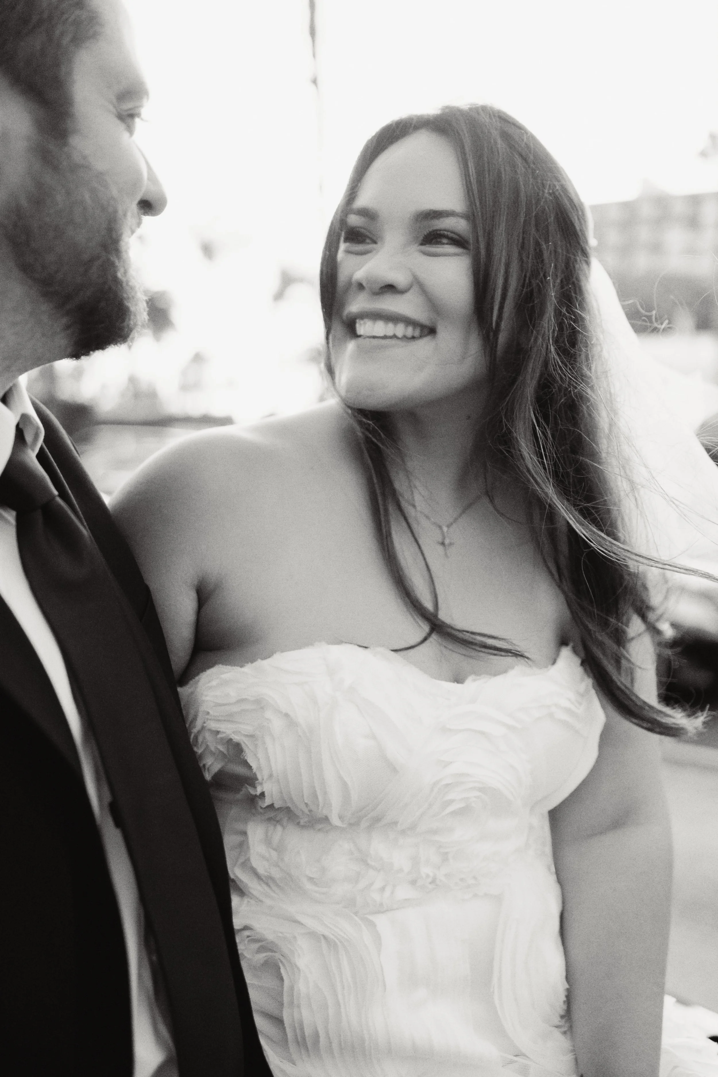 Bride and groom looking at each other lovingly in Santa Monica before their Cakewalk elopement ceremony.