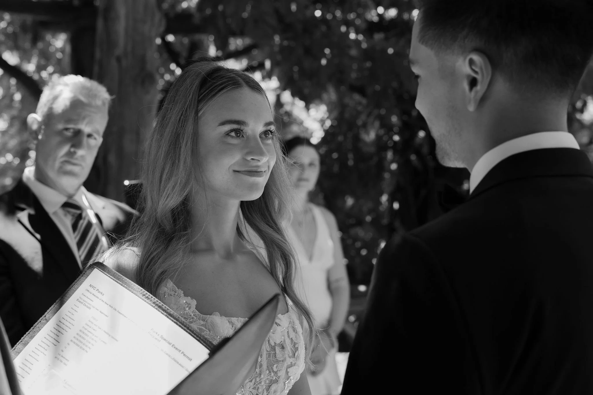 Bride staring at groom while Cakewalk officiant marries the couple at Cop Cot in Central Park.