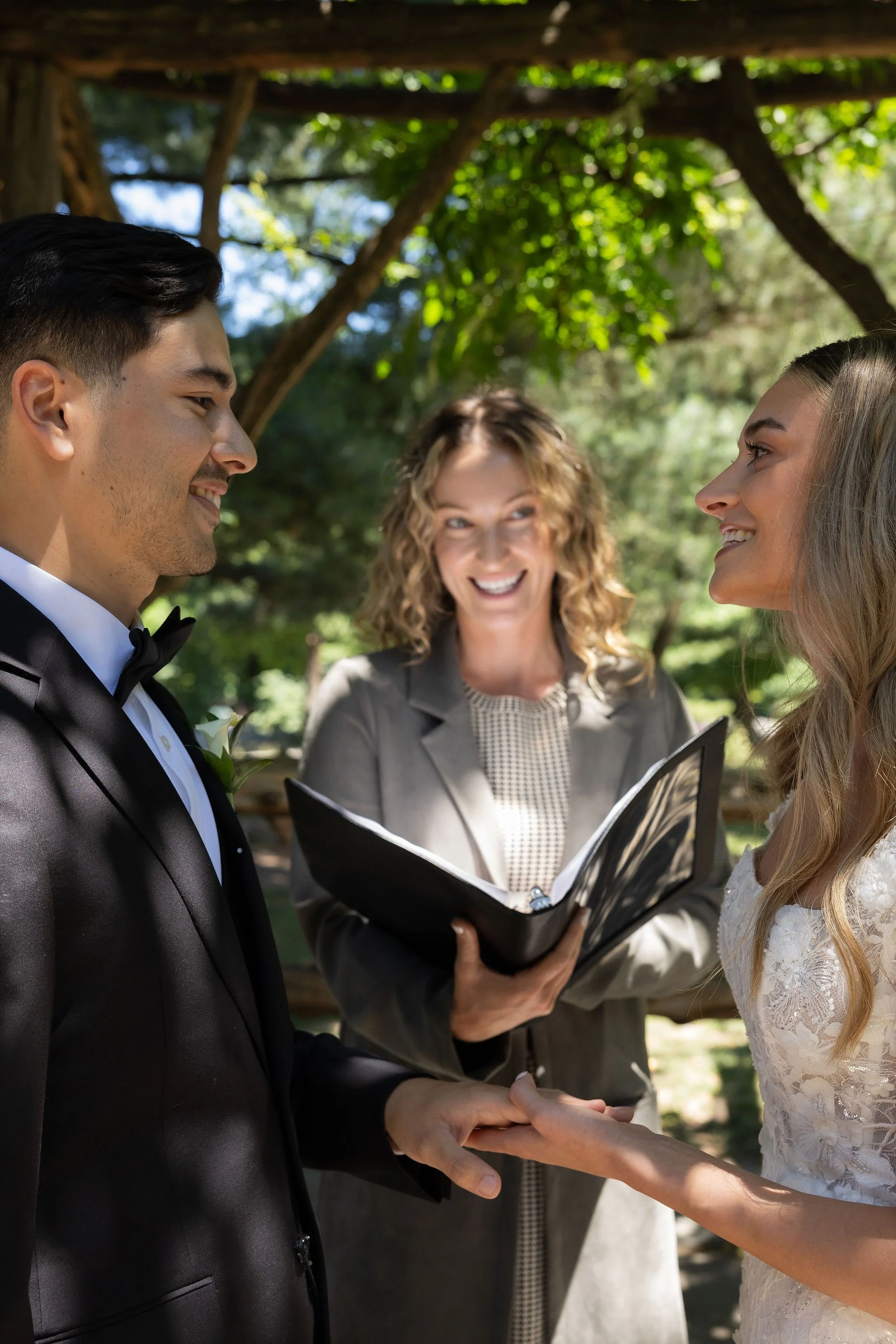 Bride and groom being married by female Cakewalk officiant at Cop Cot micro wedding in Central Park.