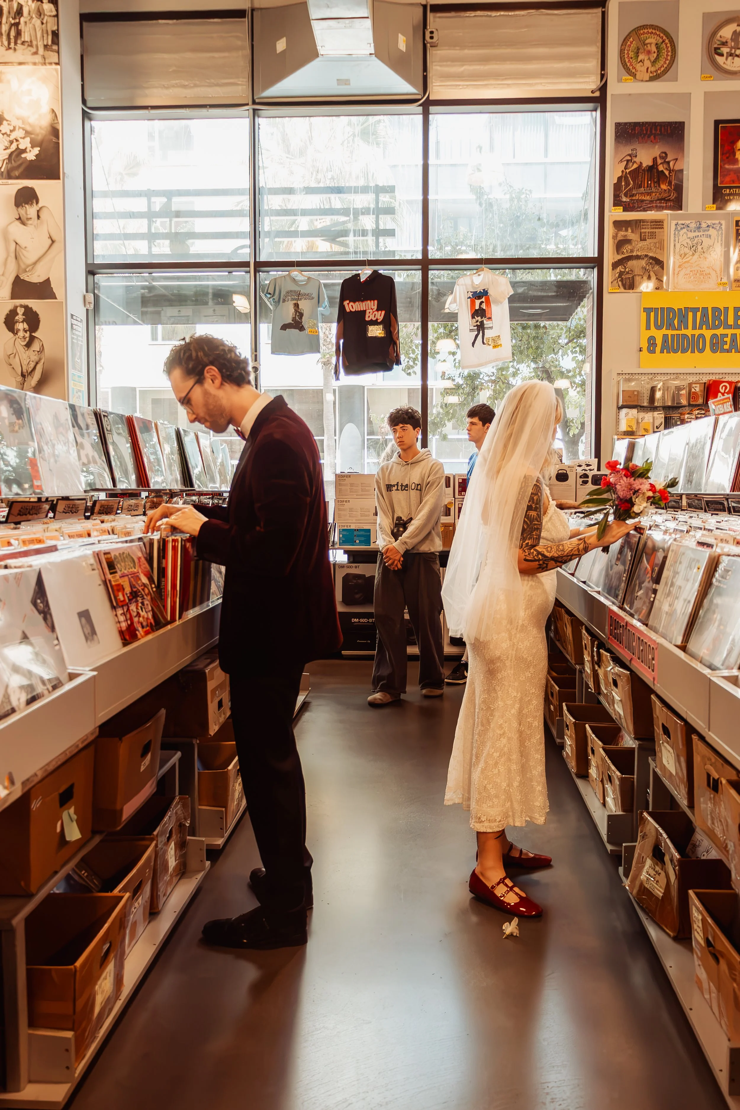 Couple looking at records at Ameoba Music in Hollywood during their Cakewalk elopement.