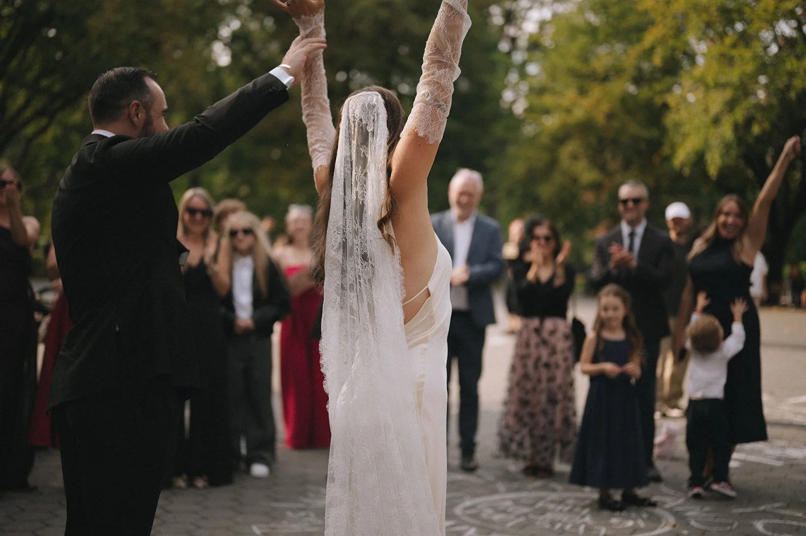 Bride and groom cheering to their guests at their Naumburg Bandshell micro wedding in Central Park by Cakewalk.