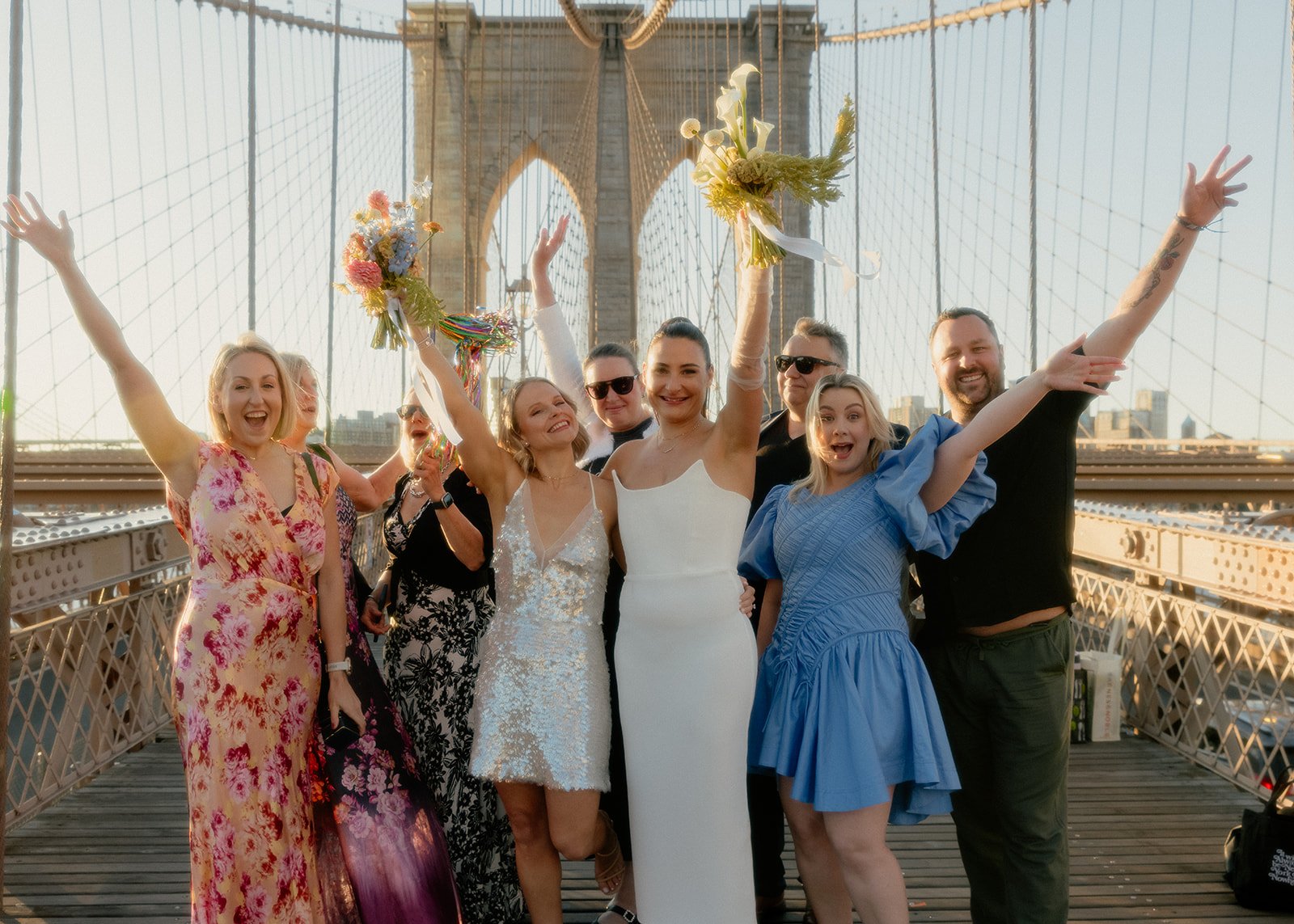 Sjaan and Megan celebrating with their nine guests on the Brooklyn Bridge at sunrise.
