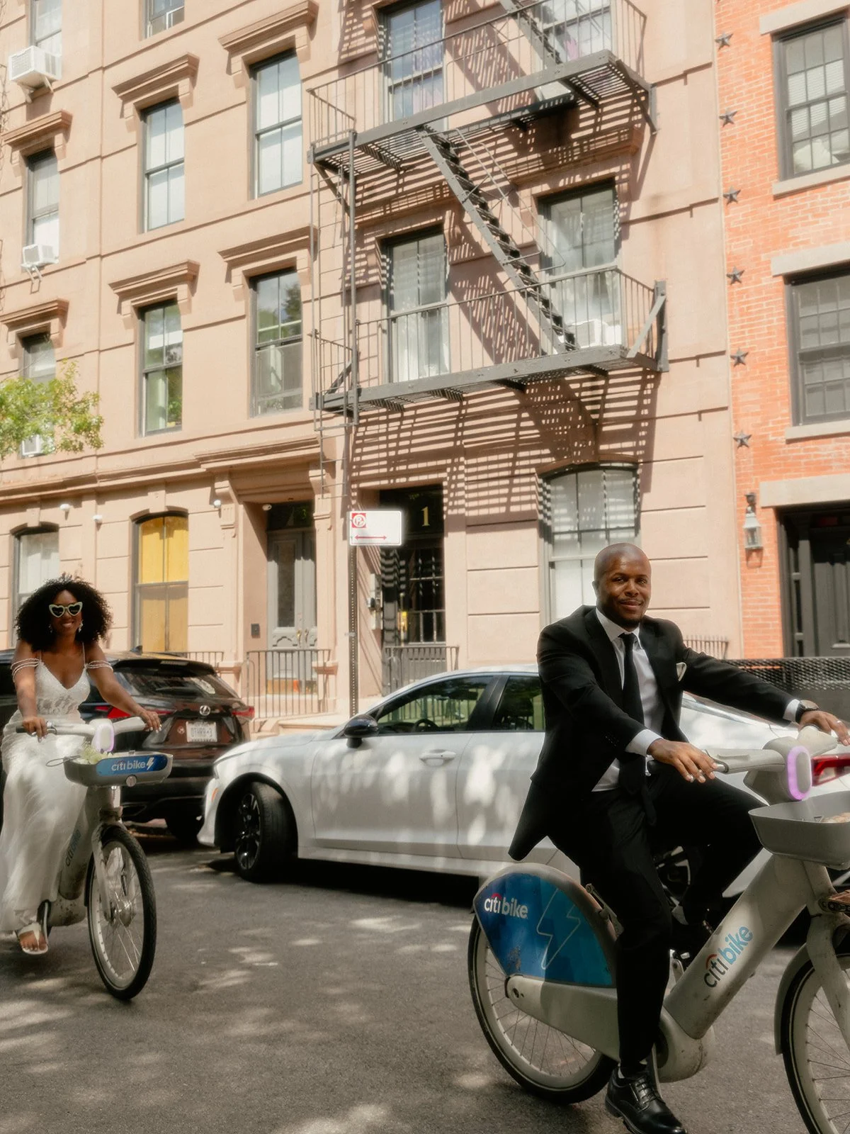 Bride and groom riding Citibikes in NYC after their Cakewalk wedding.