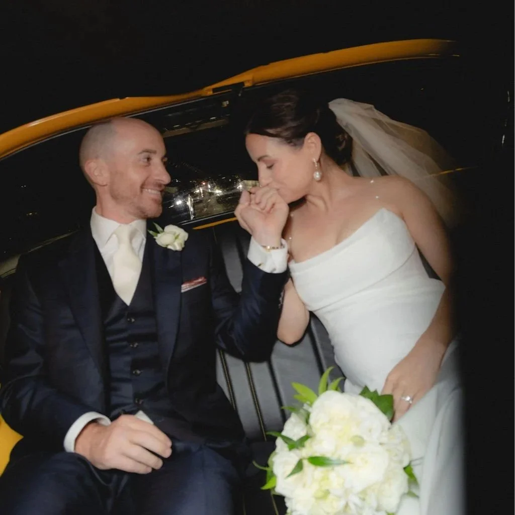 Newlyweds sharing a moment in a yellow cab after their NYC elopement ceremony
