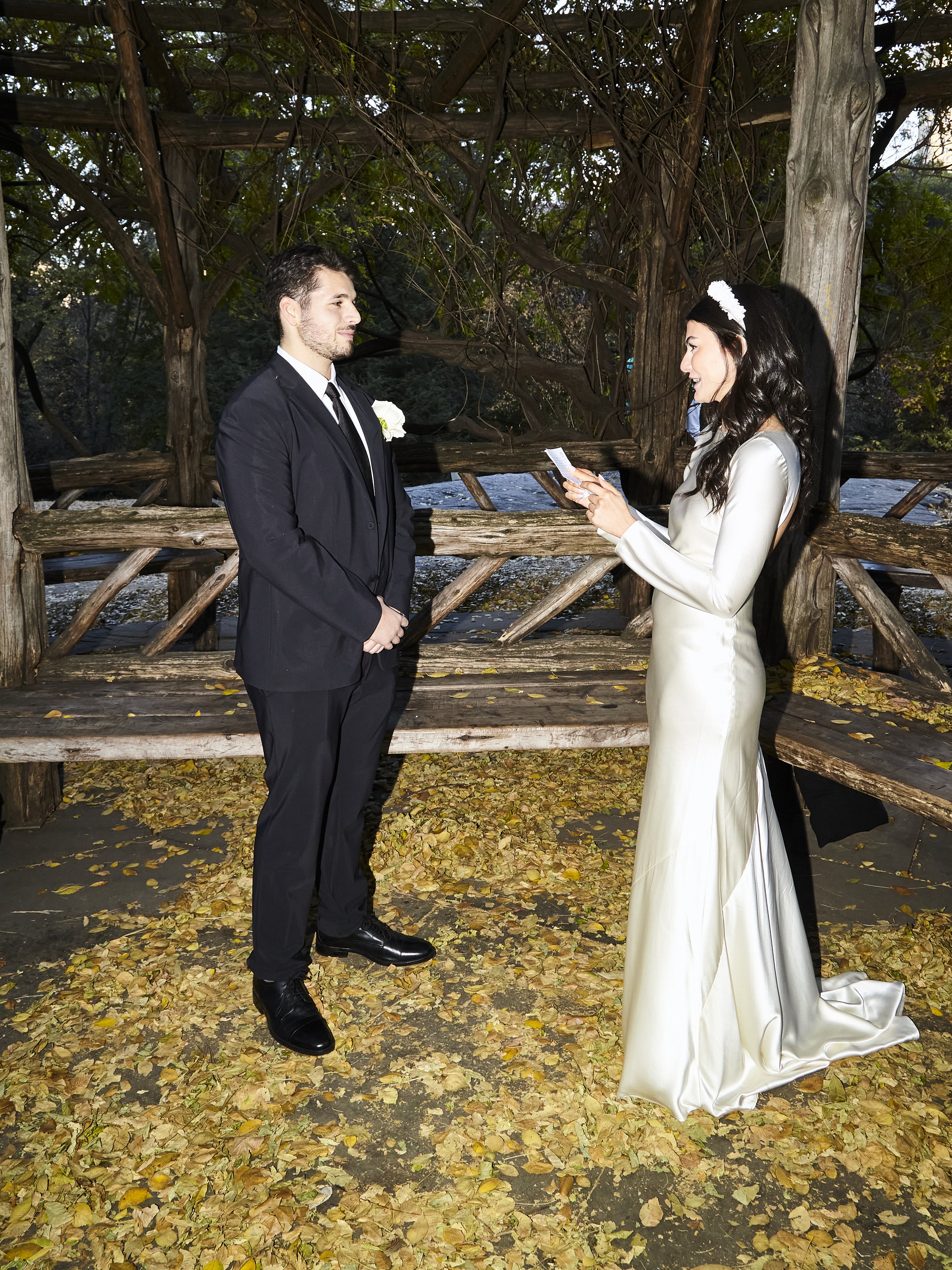 Bride and groom reading vows during their Cop Cot wedding ceremony at Central Park, planned by Cakewalk.