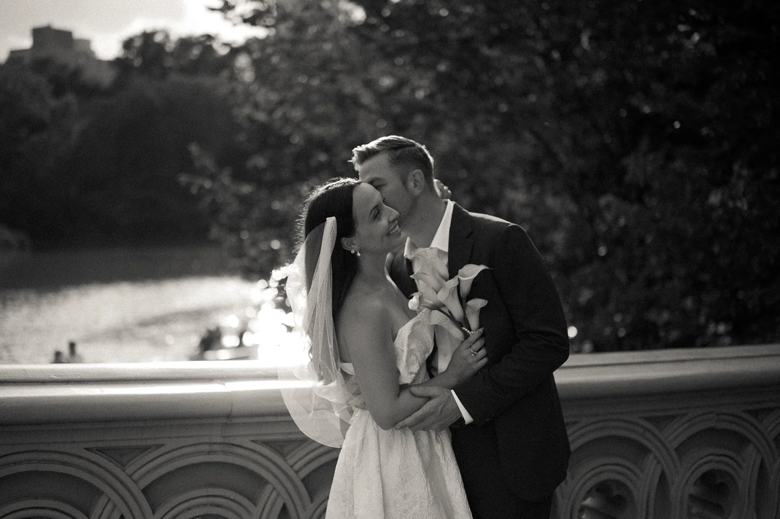 Bride and groom standing on Bow Bridge after their Central Park elopement ceremony by Cakewalk.
