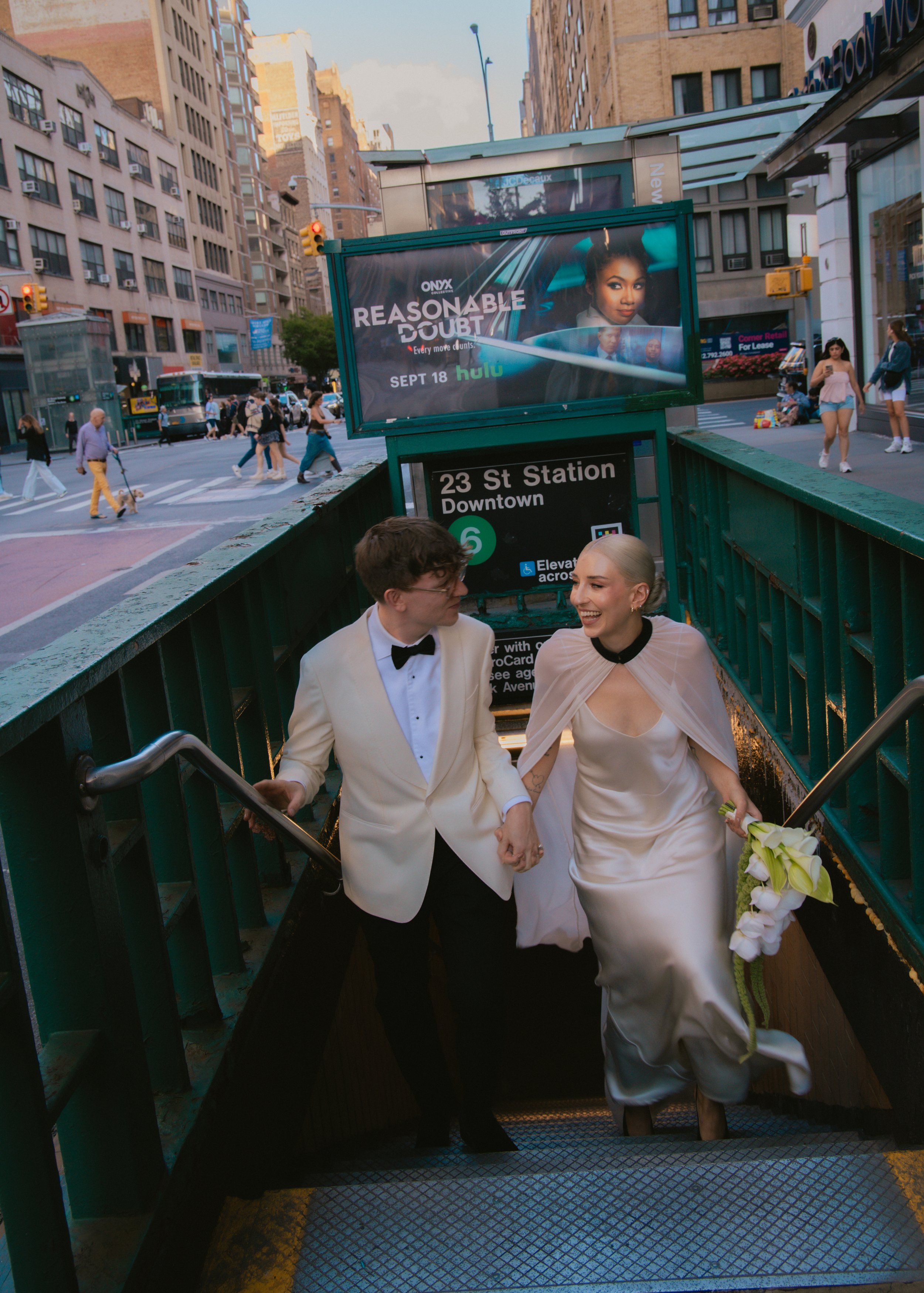 Bride and groom ascending the stairs out of 23rd Street Station in Manhattan after their Cakewalk elopement ceremony.