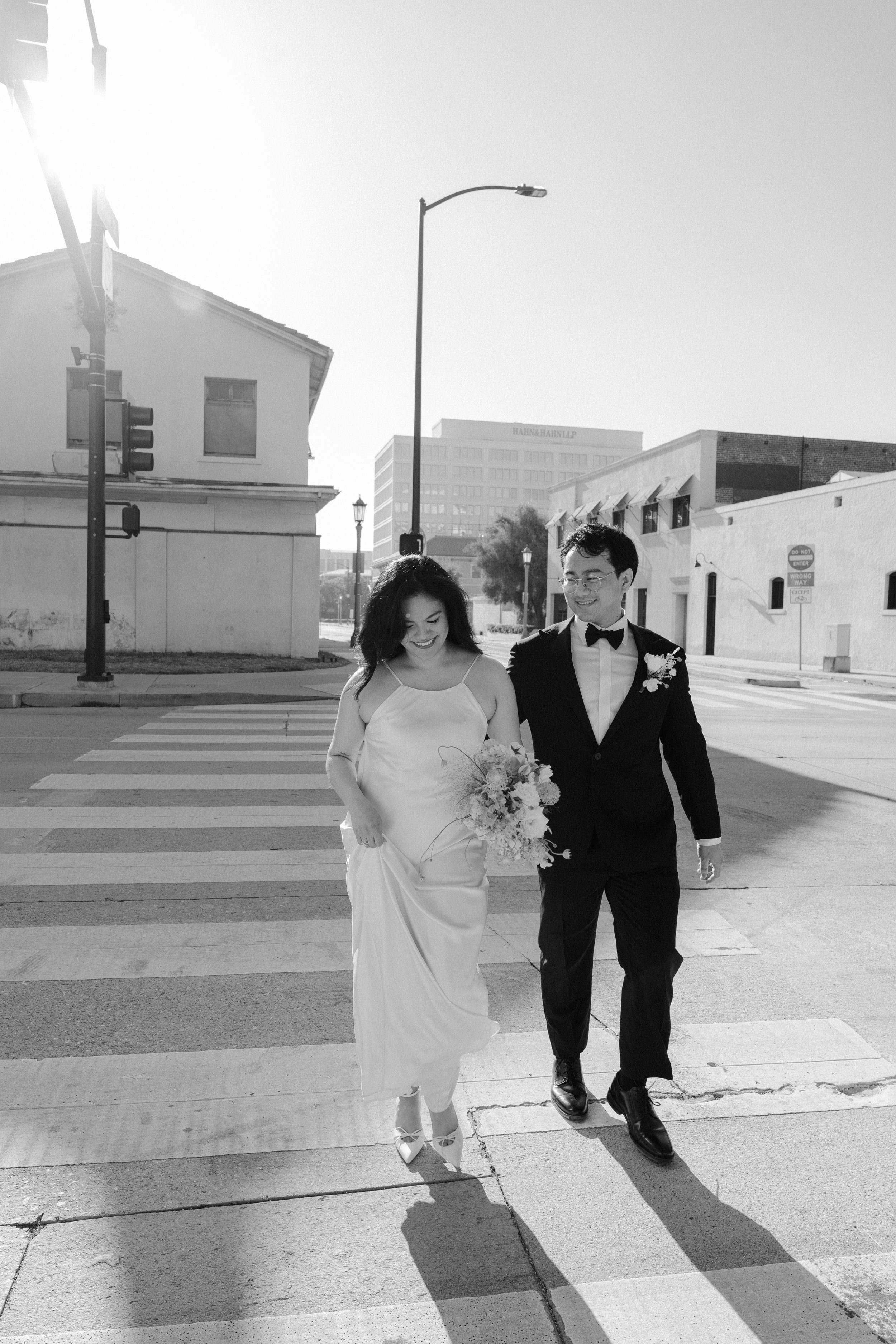 Bride and groom crossing the street in Old Pasadena after their Cakewalk elopement.
