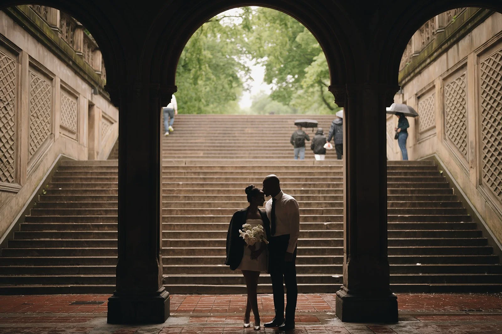 Bride and groom standing under the arches at Bethesda Terrace in Central Park after their Cakewalk elopement.