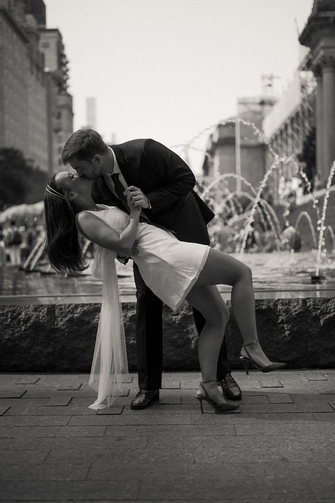 Bride and groom dancing in front of a fountain at the Met Museum of Art after their Cakewalk elopement.