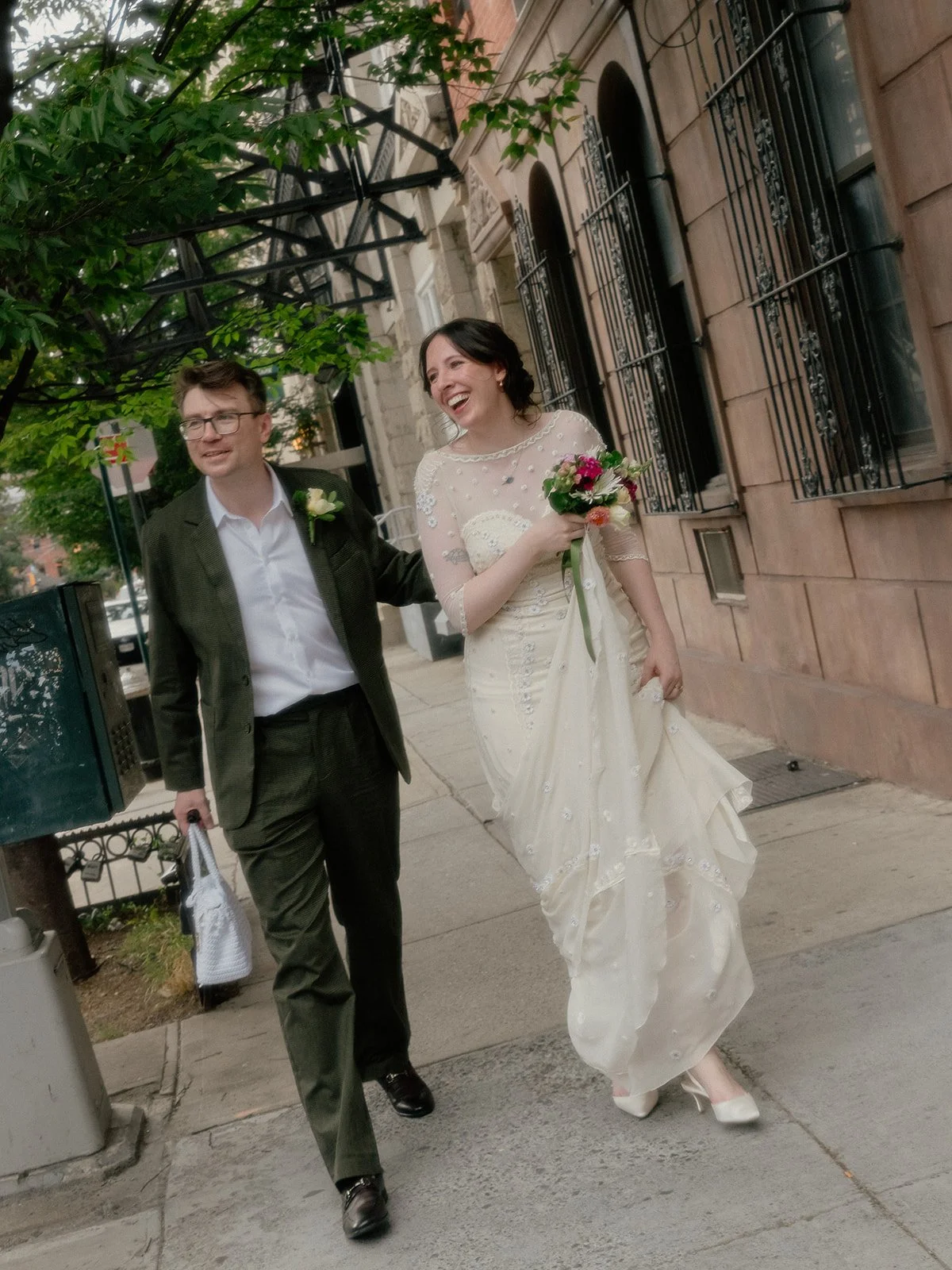 Bride and groom walking down the street in Brooklyn after their Cakewalk elopement.