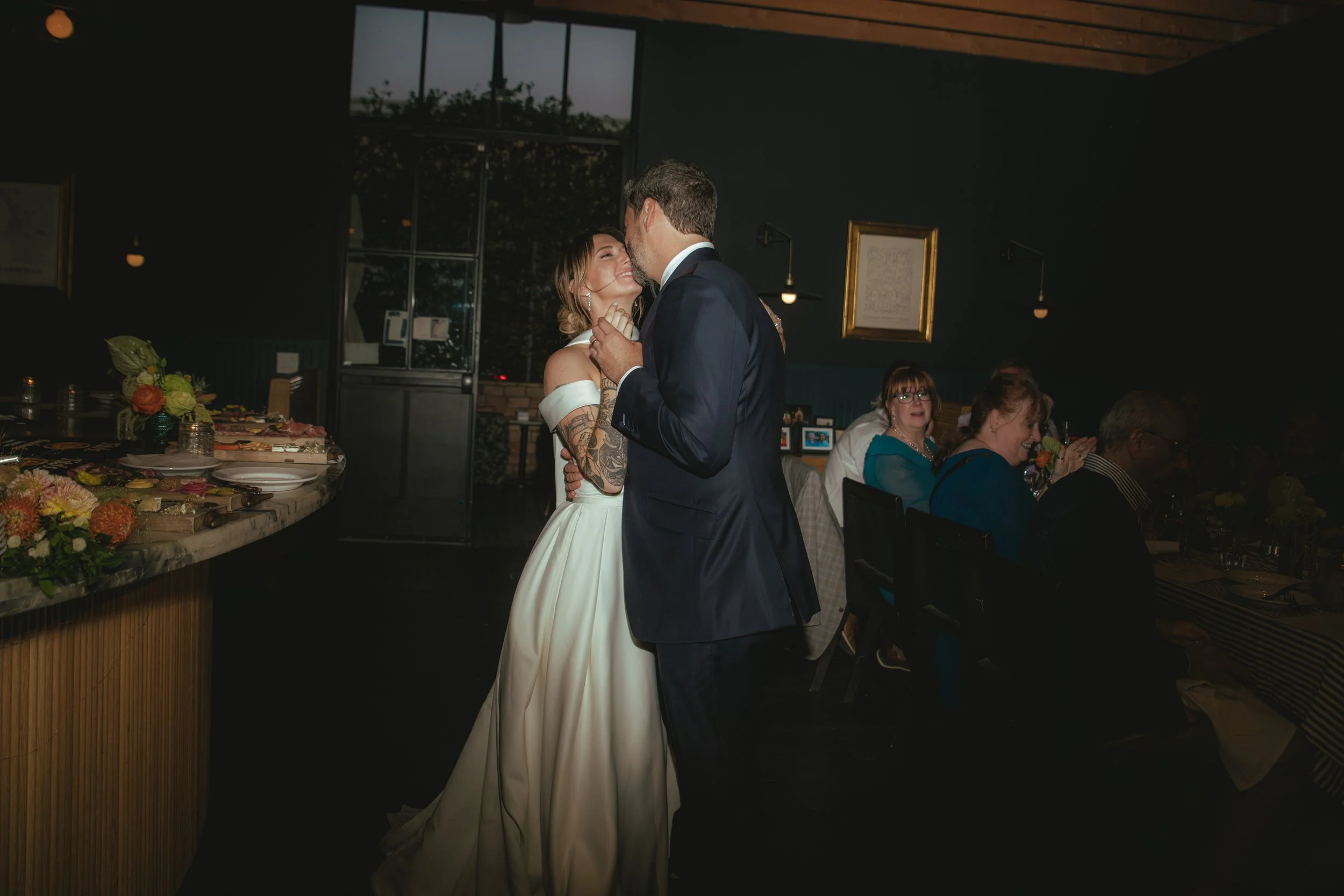 Bride and groom dancing indoors at their intimate reception after their Cakewalk wedding ceremony.