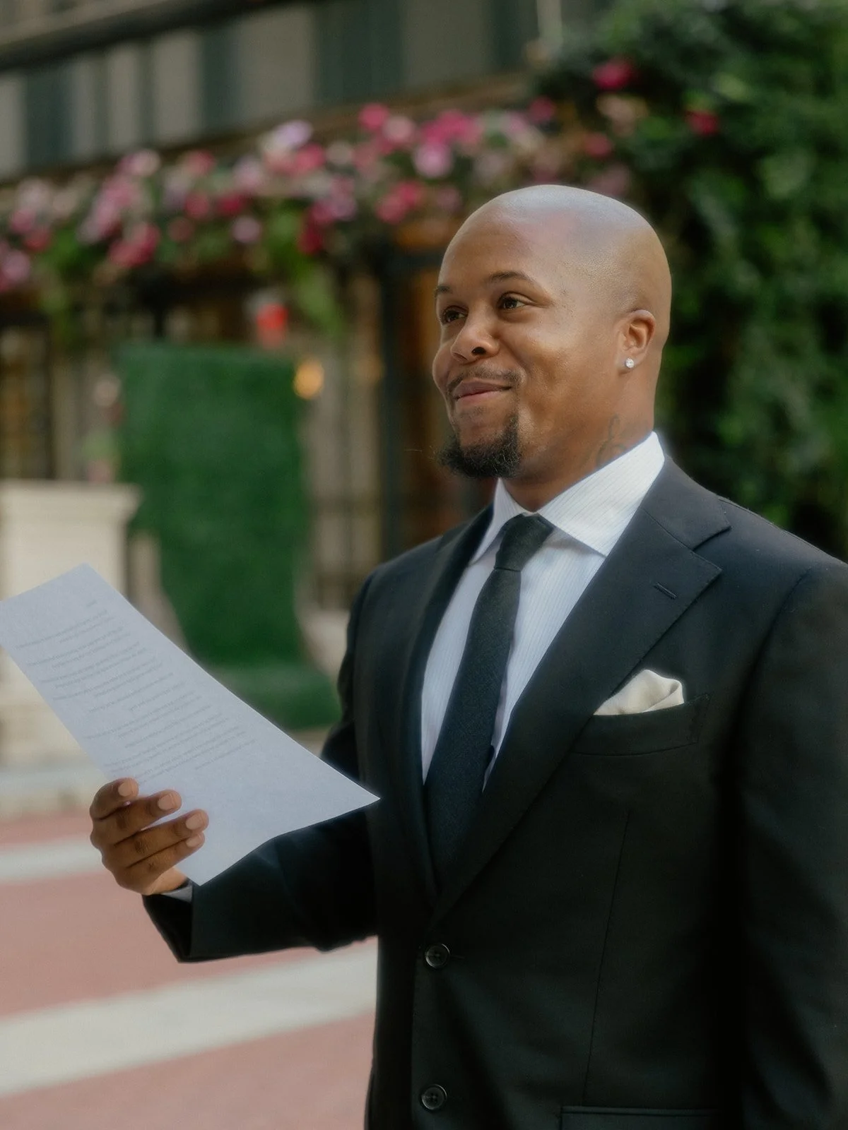 Black groom reading his vows during his Cakewalk elopement at Bryant Park.