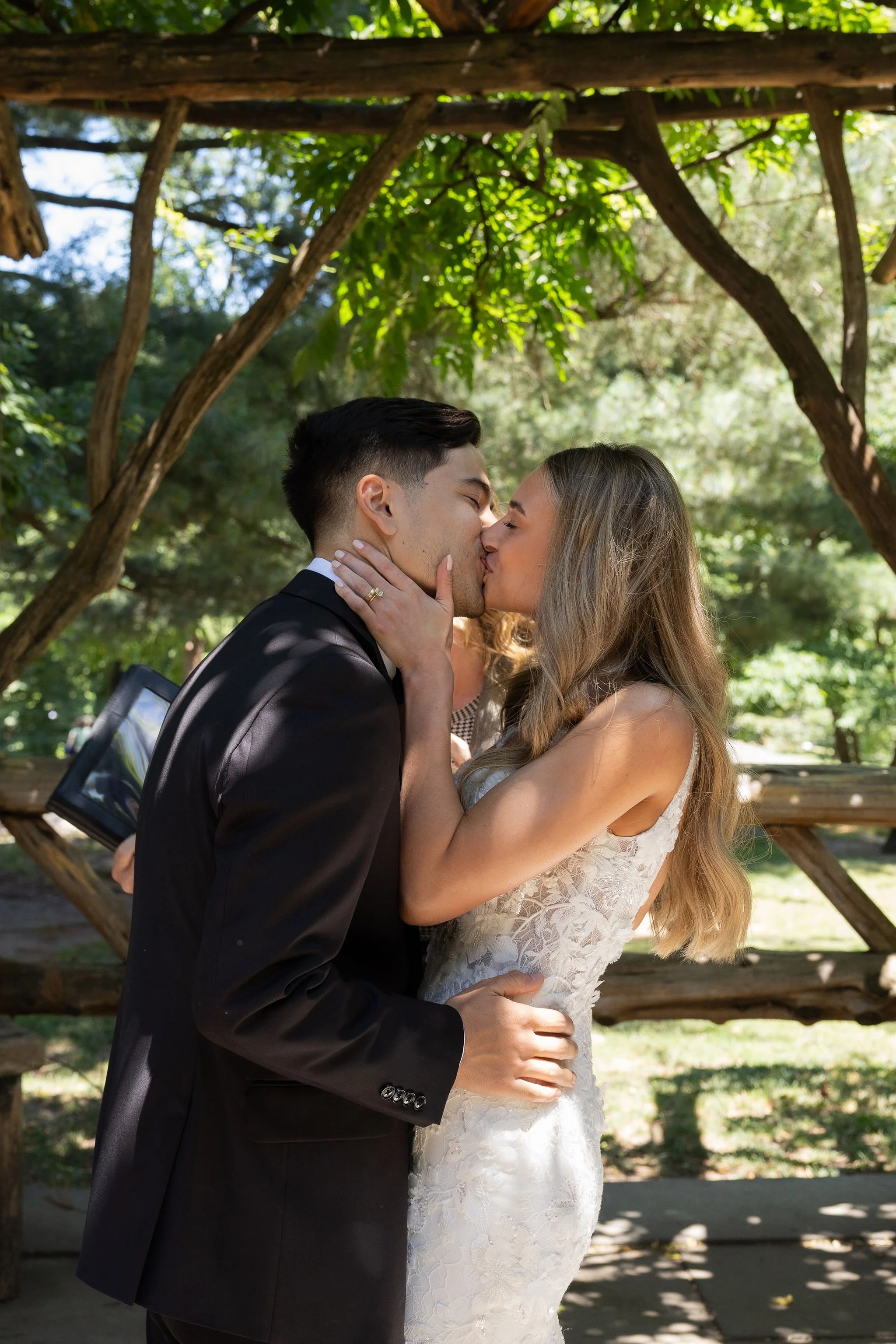 Bride and groom kissing under the gazebo at Cop Cot in Central Park at their Cakewalk micro wedding.