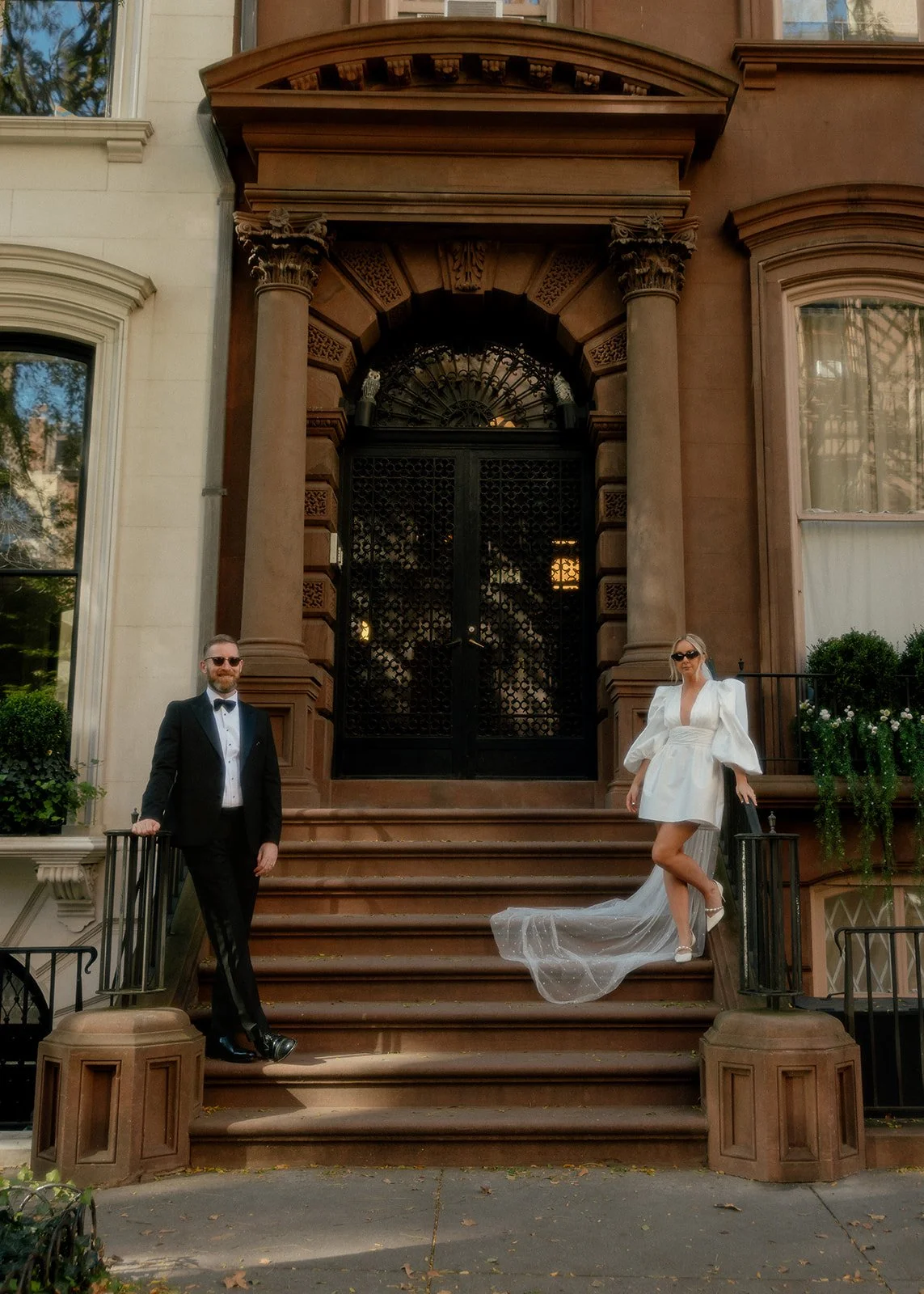 Bride and groom on the steps of a walk up in New York in Brooklyn.