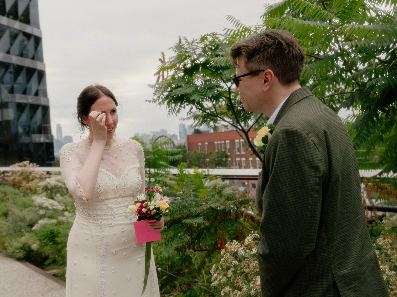 Bride and groom sharing an emotional moment on the High Line in Manhattan during their Cakewalk elopement ceremony.