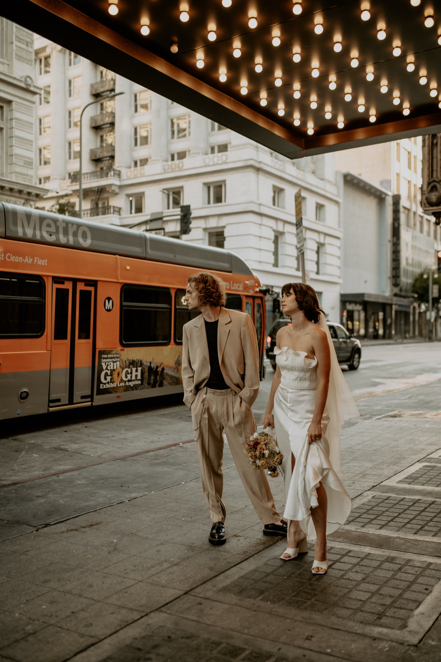 Newlyweds on a downtown LA sidewalk at sunset