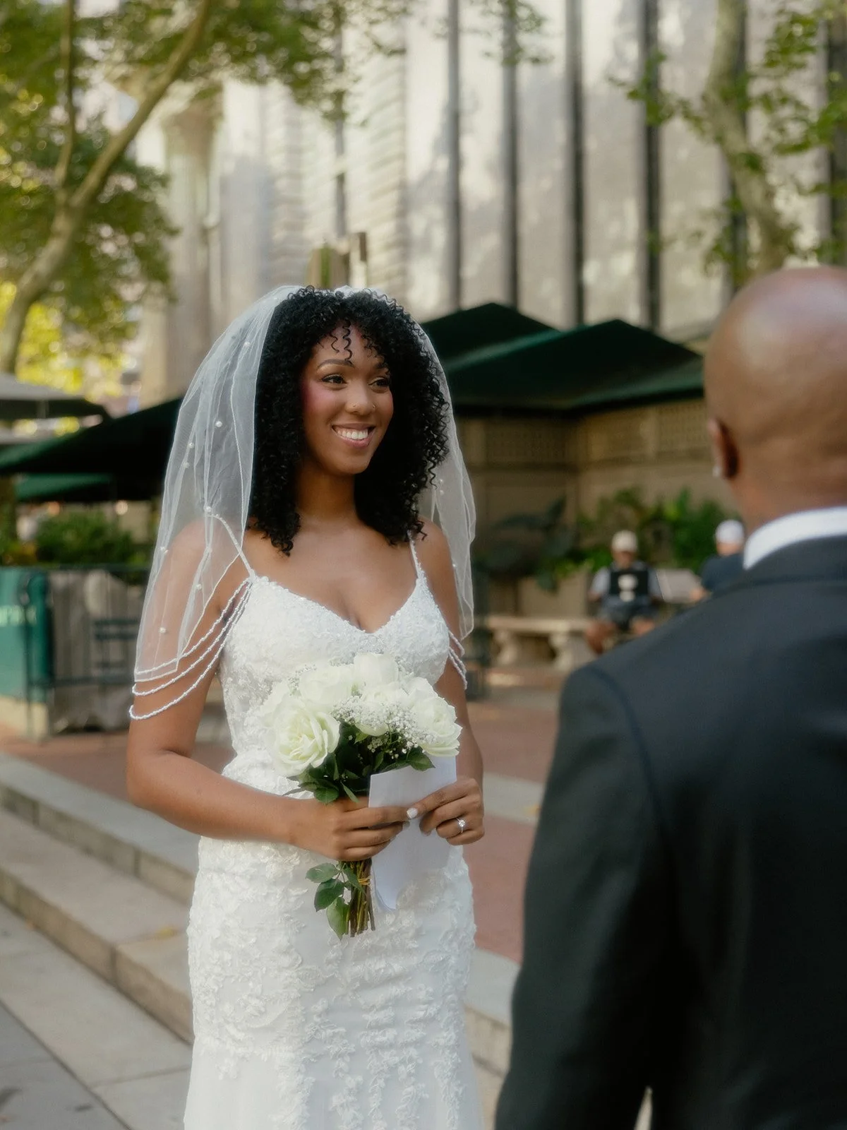 Bride looking at her husband-to-be before her elopement ceremony at Bryant Park in NYC.
