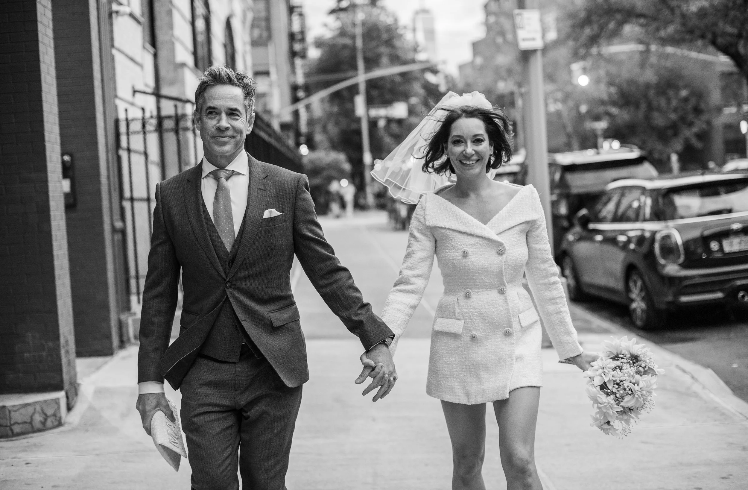 Bride and groom holding hands headed toward the West Village after their Cakewalk elopement ceremony.