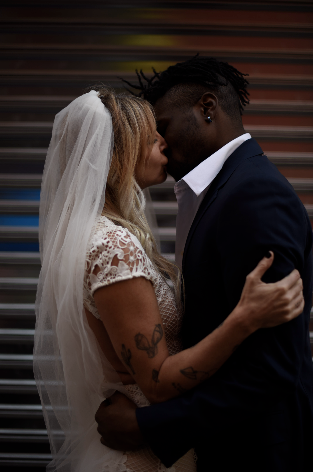 Bride and groom kissing during their elopement ceremony on Doyers Street.