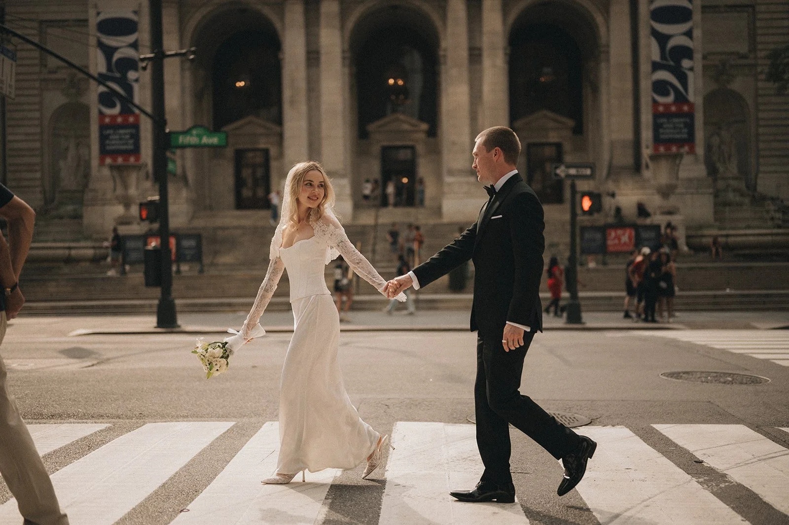 Couple crossing the street in front of the New York Public Library after their Cakewalk ceremony.