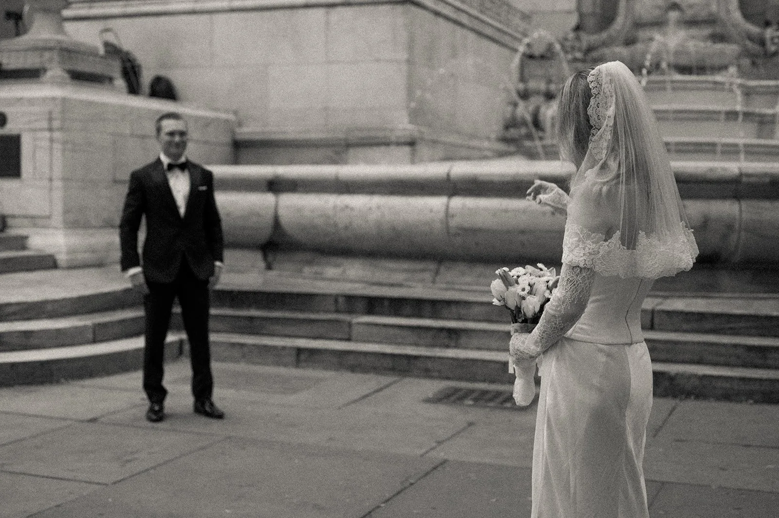 Couple admiring each other on the steps, near the fountain at the New York Public Library after their Cakewalk elopement.