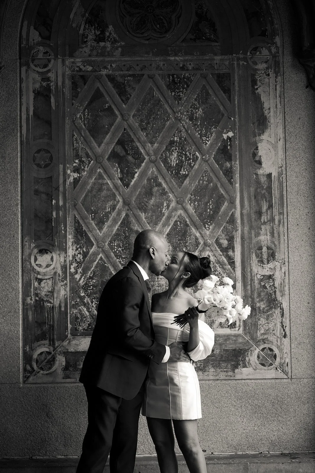 Bride and groom kissing during their Cakewalk micro wedding ceremony at Bethesda Terrace.